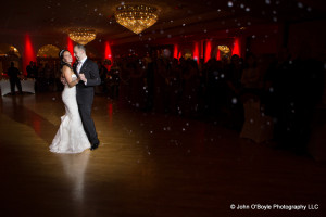bride and groom dance in ballroom with snow effect