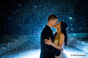 bride and groom kiss in the snow