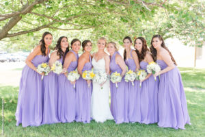 bridesmaids in lavender with white and yellow flowers