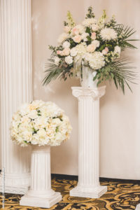white flowers on columns for wedding