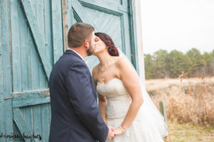 wedding kiss by barn door