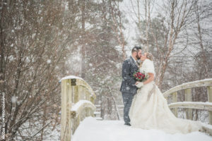 winter wedding pose on bridge