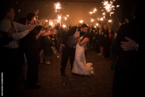 bride and groom surrounded by sparklers