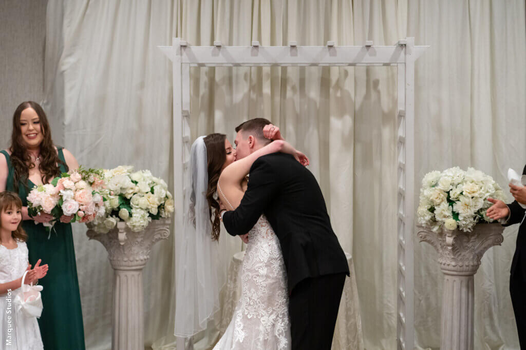 the bride and groom kiss at their ceremony