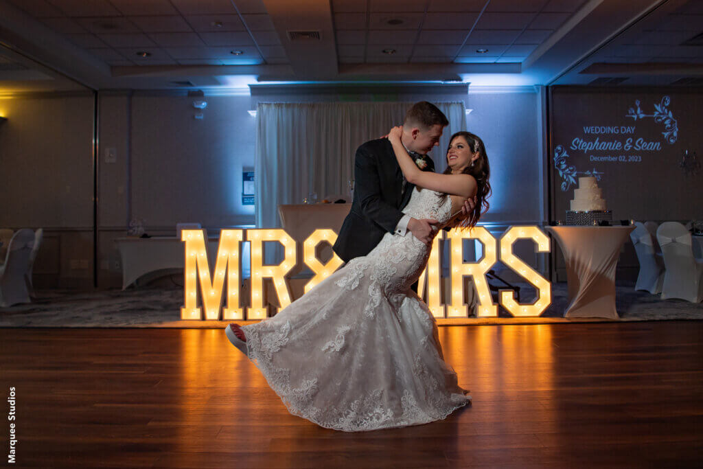 bride and groom posed on the dancefloor