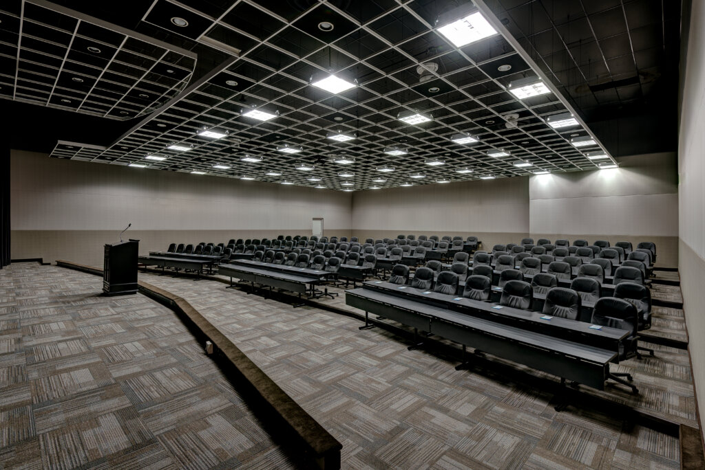 Auditorium with many chairs and tables set for a meeting